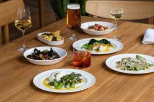 A picture of cocktails, wine and beer at The Italian Greyhound, as well as some pasta and seafood dishes