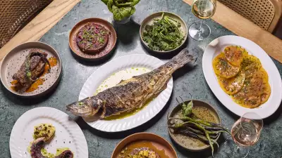 This is an image of dishes at The Counter Soho, including tomatoes, octopus and a whole fish