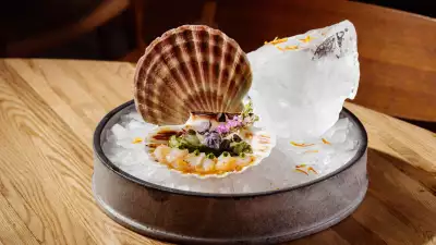 A photo of scallop sashimi with shiso pesto and pickled cucumber from ROKA