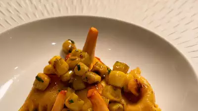 A photo of Kitchen Table's Scottish girolles butter and garlic, alongside sweetcorn agnolotti, grilled sweetcorn with tarragon, black garlic ketchup and 36-month aged Parmesan
