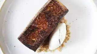 This is a photo of a buttery pain perdu and vanilla ice cream.