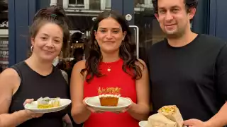 This is an image of three people holding dishes of food