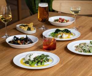 A picture of cocktails, wine and beer at The Italian Greyhound, as well as some pasta and seafood dishes
