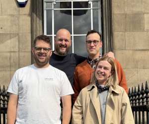 This is an image of four people standing together