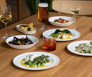 A picture of cocktails, wine and beer at The Italian Greyhound, as well as some pasta and seafood dishes