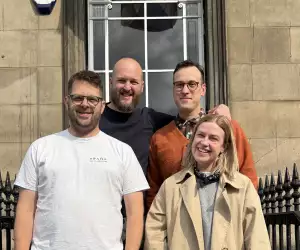 This is an image of four people standing together